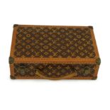 A 1920’s Louis Vuitton miniature suitcase, stamped L.Vuitton, 20 x 13 x 6cm.Overall of good original