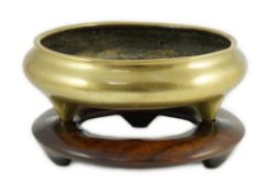 A large Chinese polished bronze tripod censer, 19th century, private four character seal mark, 29.