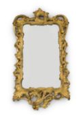 A George III carved giltwood wall mirror, of serpentine rectangular form, with pierced foliage and