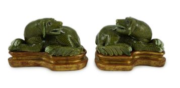 A pair of Chinese green glazed models of hounds, 19th century, each with open mouth and protruding