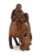 A Chinese bamboo group of boy riding a buffalo, 18th/19th century, of caramel brown patina, 12.5