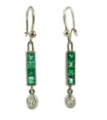 A pair of white gold, four stone emerald and single stone oval cut diamond set drop earrings,