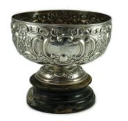 A late Victorian embossed silver pedestal punch bowl by Mappin Brothers (a.f.), decorated with