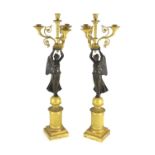 A pair of 19th century French Empire style bronze and ormolu four light candelabra, each with female