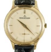A gentleman's 9ct gold Jaeger LeCoultre manual wind dress wrist watch, on associated strap, with