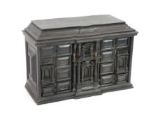 An early 18th century Portuguese ebonised table cabinet, of architectural form, with central door