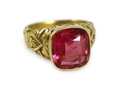 An antique Tiffany & Co gold and singe stone cushion cut rubellite set dress ring, with pierced