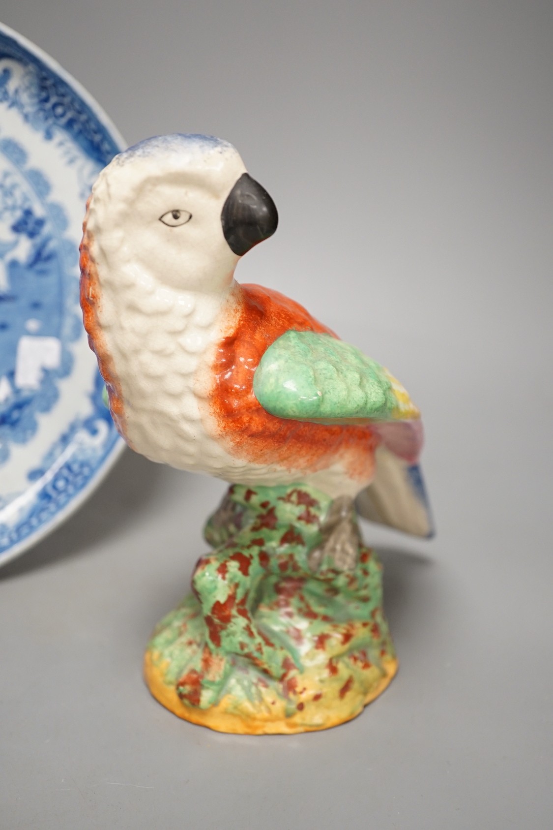 A Staffordshire pottery figure of a parrot, 19.5cm tall, together with a blue and white dish - Image 2 of 5