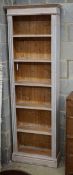 A Victorian style painted pine narrow open bookcase, width 65cm, depth 20cm, height 200cm