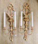 A pair of Louis XVI style carved giltwood wall lights, with ribbon crests and winged eagle stems,
