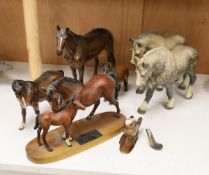 A collection three single Beswick horses, a group figure of a mother and foal, a wall pocket and two