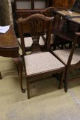 A set of nine George III and later mahogany dining chairs with pierced splats and upholstered drop