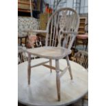 A set of eight Victorian style limed beech Windsor wheelback elbow chairs