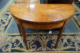 A George III satinwood demi lune folding card table, width 97cm, depth 47cm, height 73cm