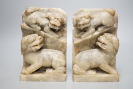A pair of Chinese soap stone lion dog carvings, 17cm tall