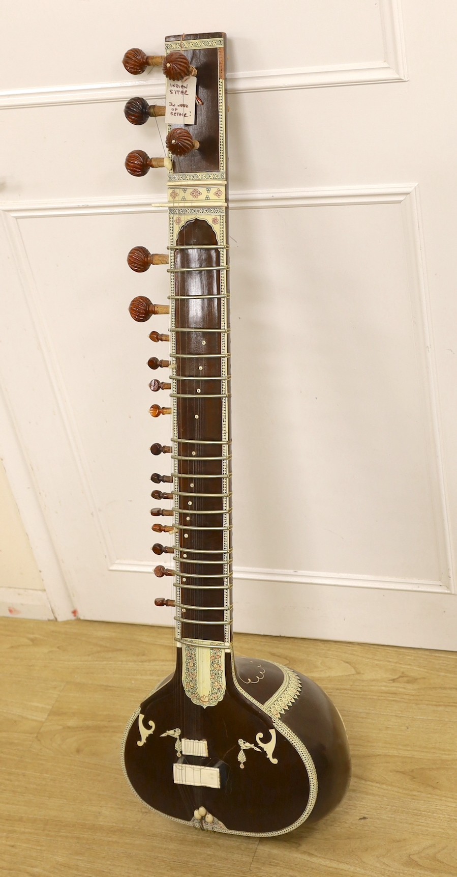 An Indian Sitar (in need of repair) with hard case,123cms high.