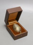 A cased modern silver gilt surprise egg, in the manner of Stuart Devlin, by Richard Lawrence