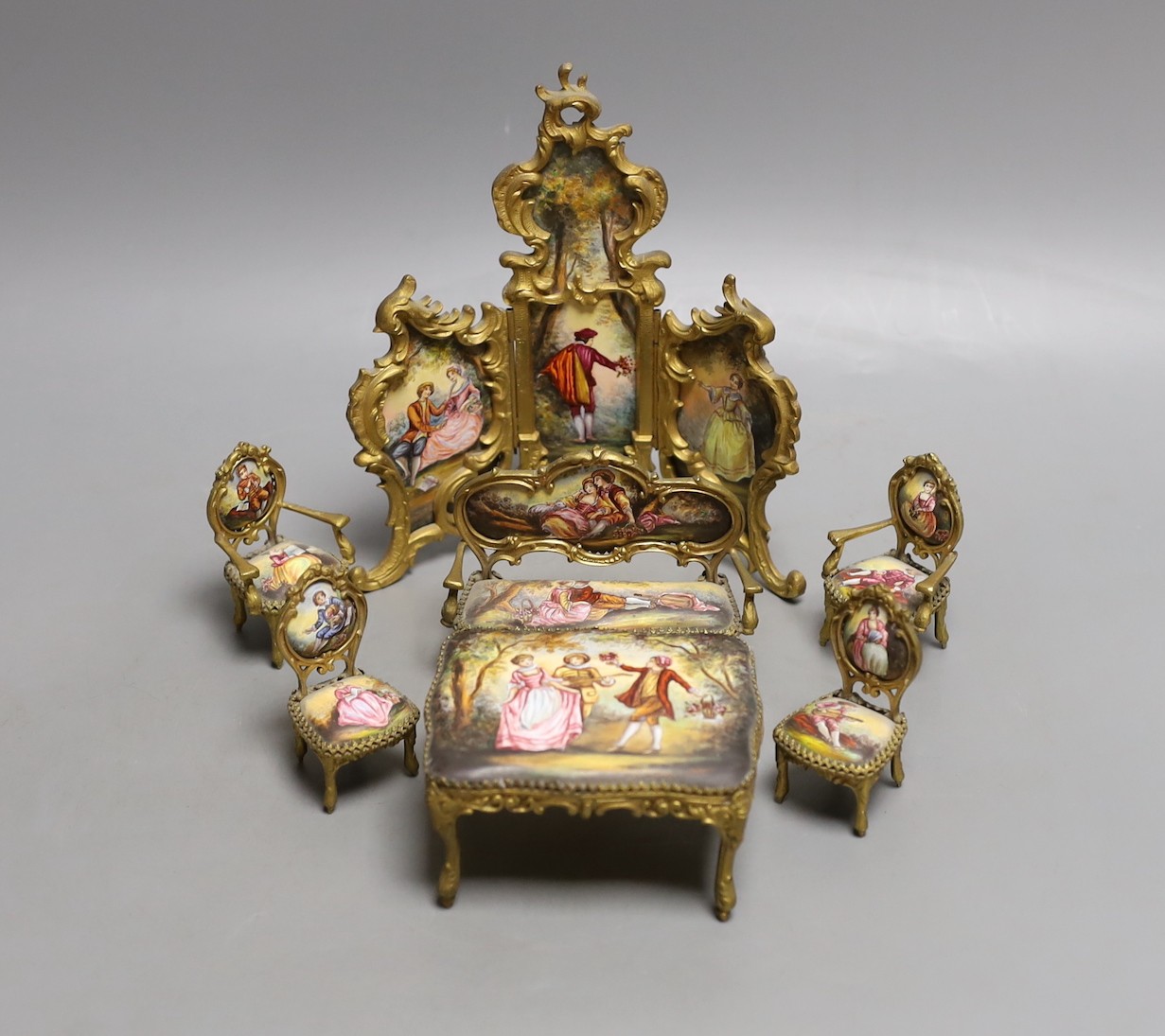 A suite of Viennese enamelled miniature furniture: 3 fold screen, table, salon sofa, a pair of