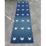 A contemporary wool runner with star motifs, 300 x 76cm