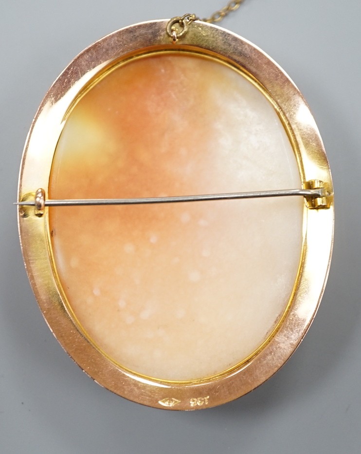 A 9ct mounted oval cameo shell brooch, carved with two ladies in a townscape, 58mm, gross weight - Image 2 of 2