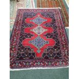 A North West Persian red ground rug, 156 x 120cm