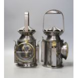 A pair of polished steel lamps, one dated 1945 - 30cm tall