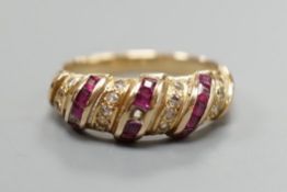 A modern 585 yellow metal, ruby and diamond chip set half hoop ring, size M/N, gross weight 3.3