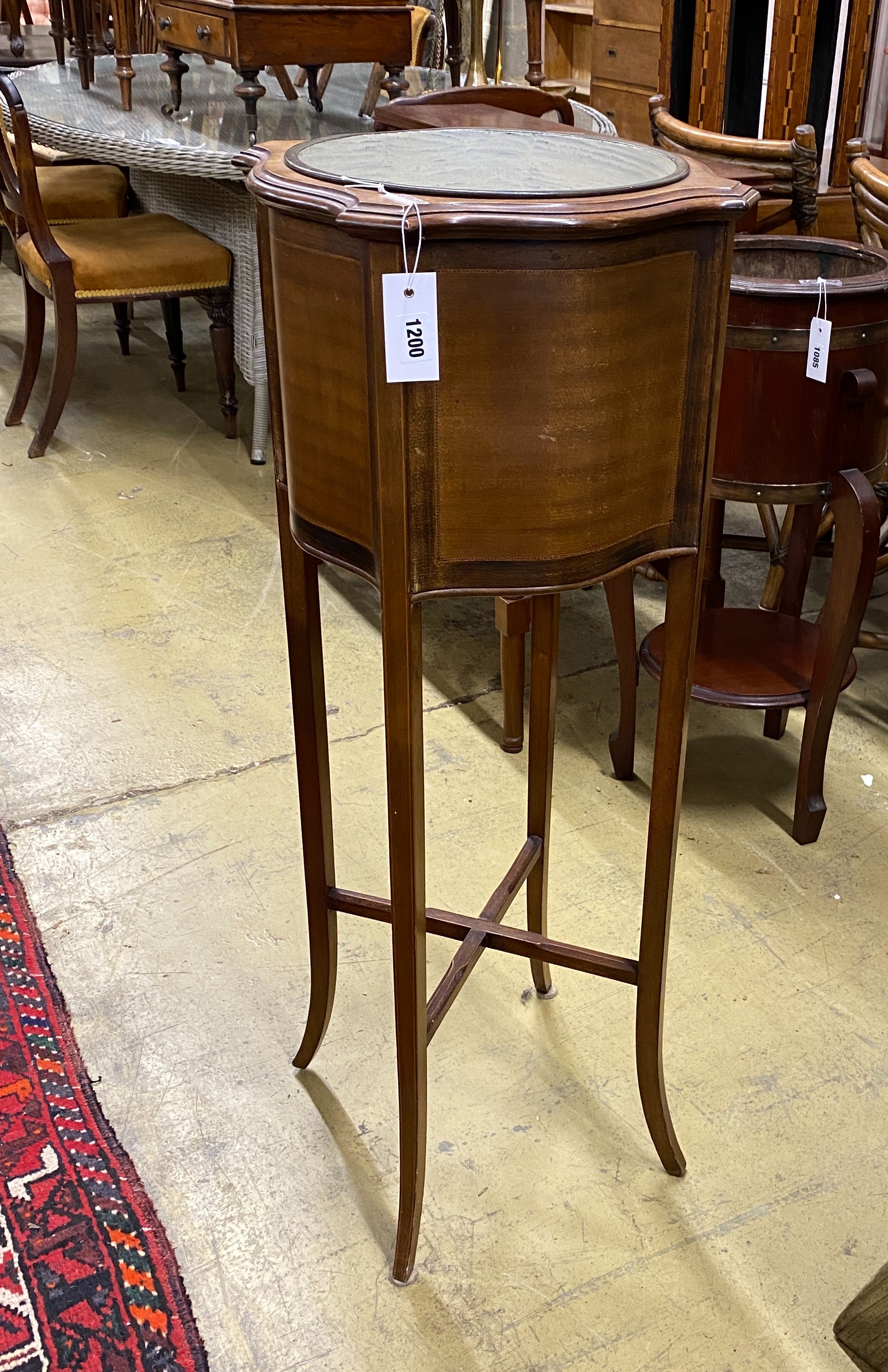 An Edwardian inlaid mahogany jardiniere of circular serpentine form, width 37cm, height 99cm