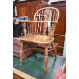 A Victorian yew and elm Windsor elbow chair, with crinoline stretcher, width 53cm, depth 44cm,