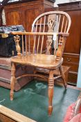 A Victorian yew and elm Windsor elbow chair, with crinoline stretcher, width 53cm, depth 44cm,