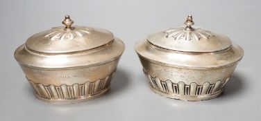 A matched pair of early 20th century silver oval tea caddies, London, 1908 & 191, width 10.5cm and