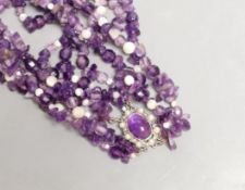 A quadruple strand amethyst pebble necklace, with white bead spacers and white metal clasp, 50cm
