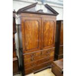 A George III flamed mahogany linen press with broken arch pediment, interior adapted, width 64cm,