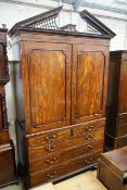 A George III flamed mahogany linen press with broken arch pediment, interior adapted, width 64cm,