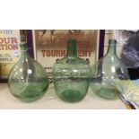 Three green glass carboys, one converted to a lamp - tallest 40cm