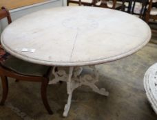 A Victorian style circular painted pine circular dining table on painted cast metal base, diameter