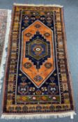 A Caucasian design blue ground rug, 204 x 104cm