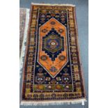 A Caucasian design blue ground rug, 204 x 104cm