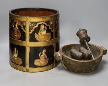 An African carved wood bowl, a Tibetan prayer wheel and a Persian waste basket