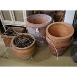 Four circular terracotta garden planters, together with a square planter, largest diameter 48cm,