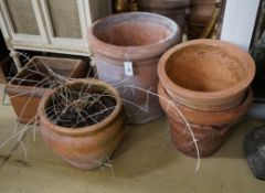Four circular terracotta garden planters, together with a square planter, largest diameter 48cm,