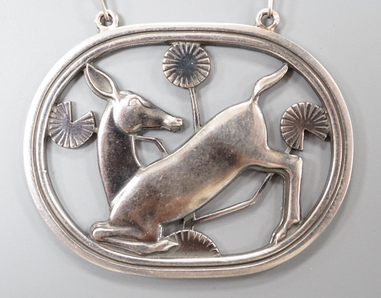 A Georg Jensen sterling 'kneeling deer' oval pendant necklace, no. 95, pendant 42mm, chain 53cm.