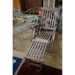 A weathered teak garden steamer chair with brass fittings