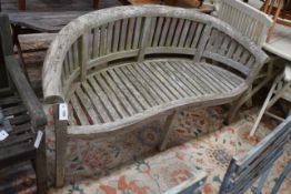 A weathered teak garden banana bench, length 160cm, depth 60cm, height 86cm