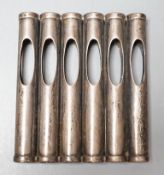 An Edwardian patent novelty cigarette holder, modelled as a magazine of bullets, William Maguires,