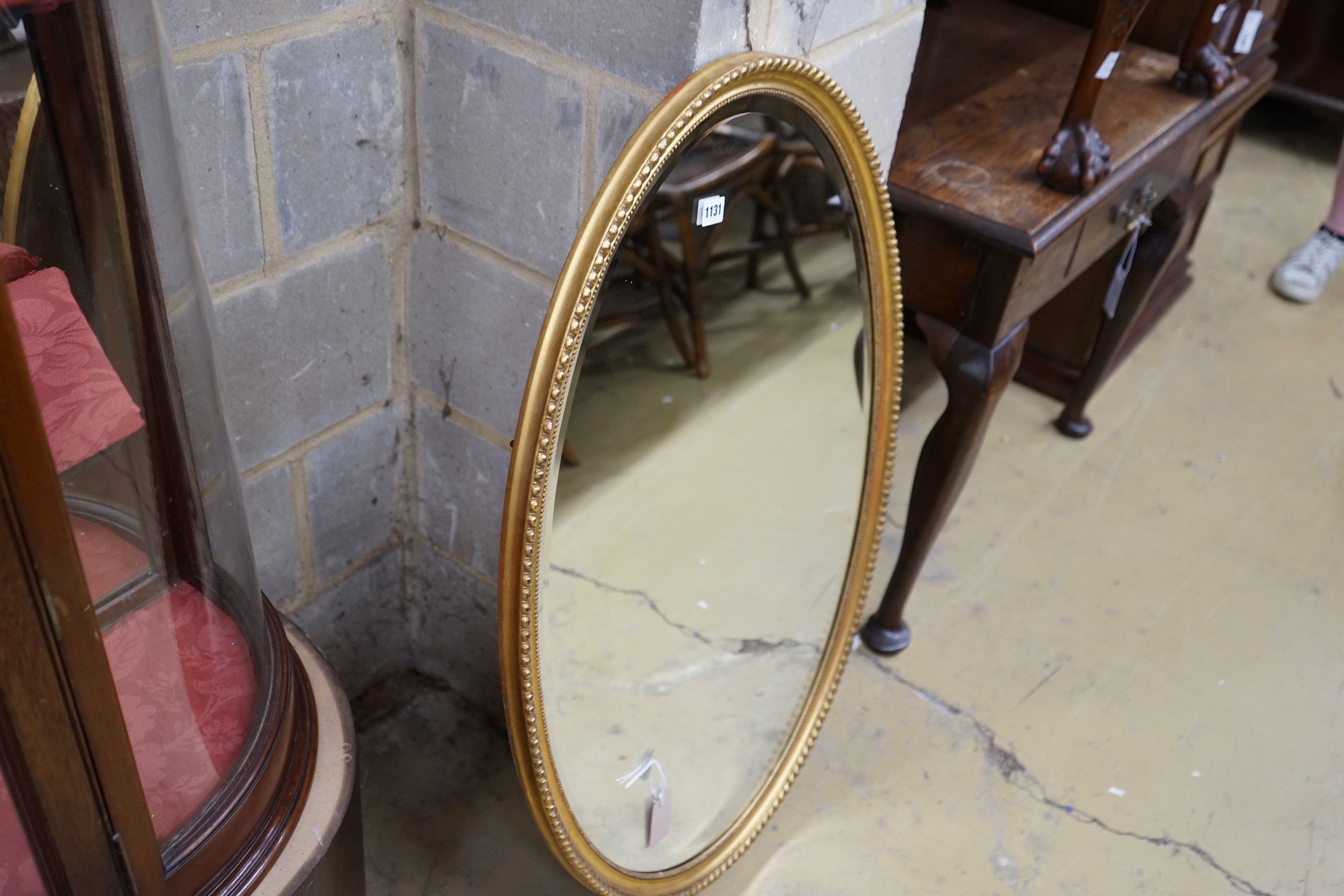 An oval gilt framed wall mirror, width 66cm, height 98cm - Image 2 of 2