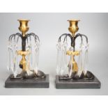 A pair of gilt bronze and glass lustre drop 'sphinx' candlesticks, 21cm