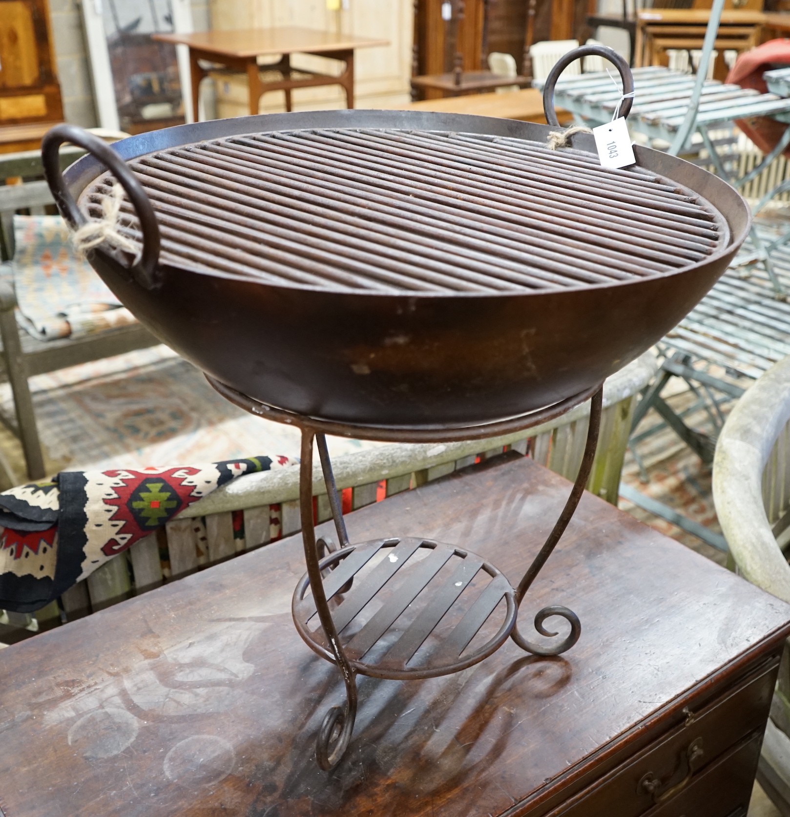 A circular wrought iron fire pit, diameter 61cm, height 59cm