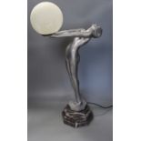 An Art Deco style figurative lamp of a lady holding a frosted glass globe,66cms high.