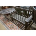 A weathered teak garden bench and an octagonal garden table, width 100cm, height 69cm